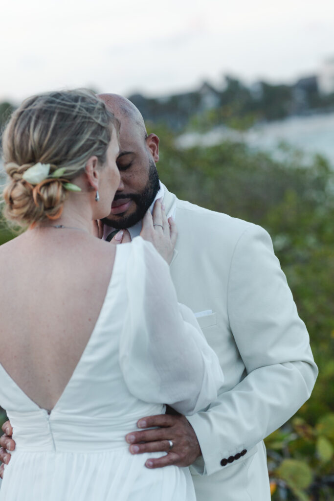 Messy low bridal updo hairstyle at Blue Venado Wedding by Sarah Garnier Hair & Makeup Artists in Riviera Maya, Mexico